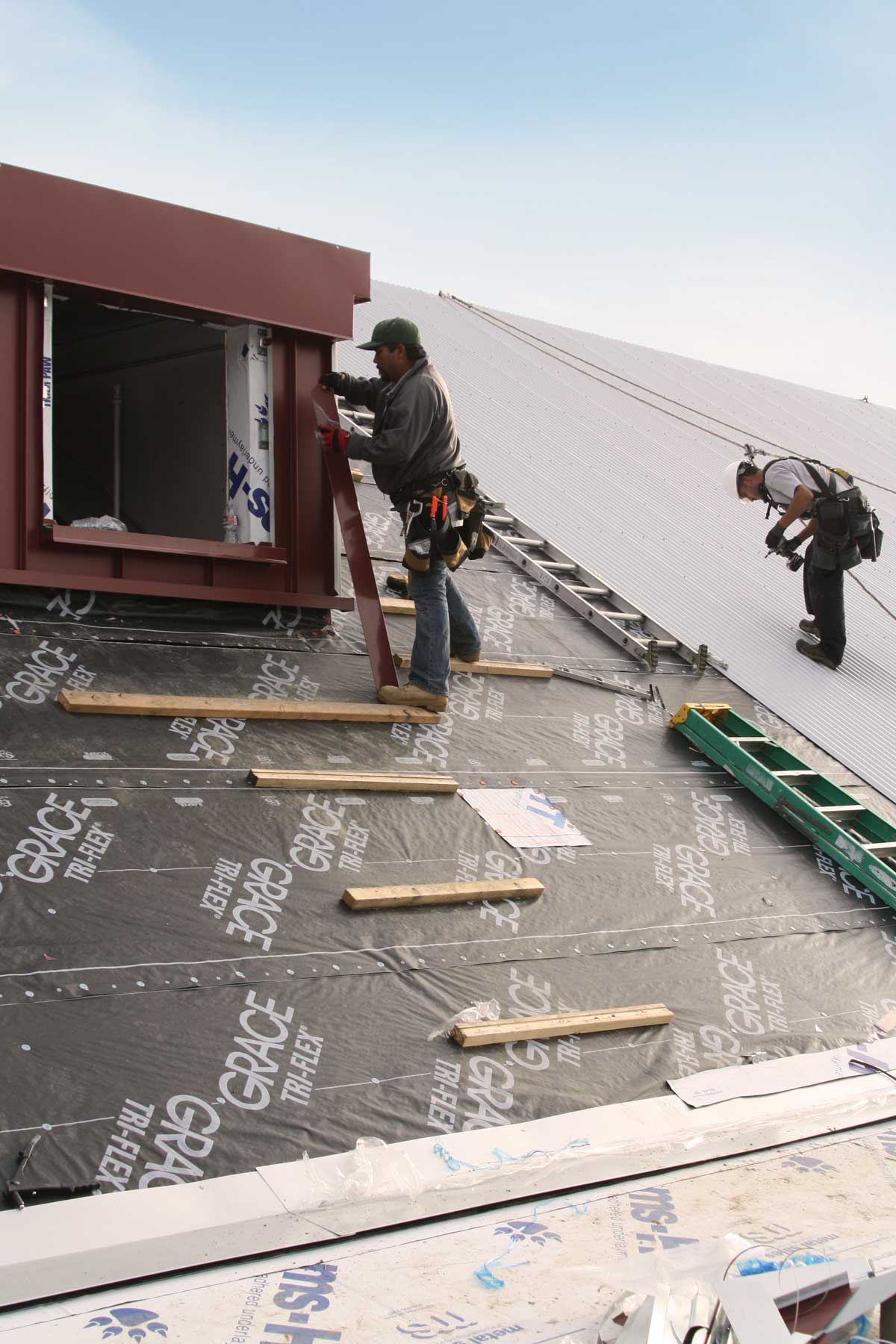 team installing metal roof